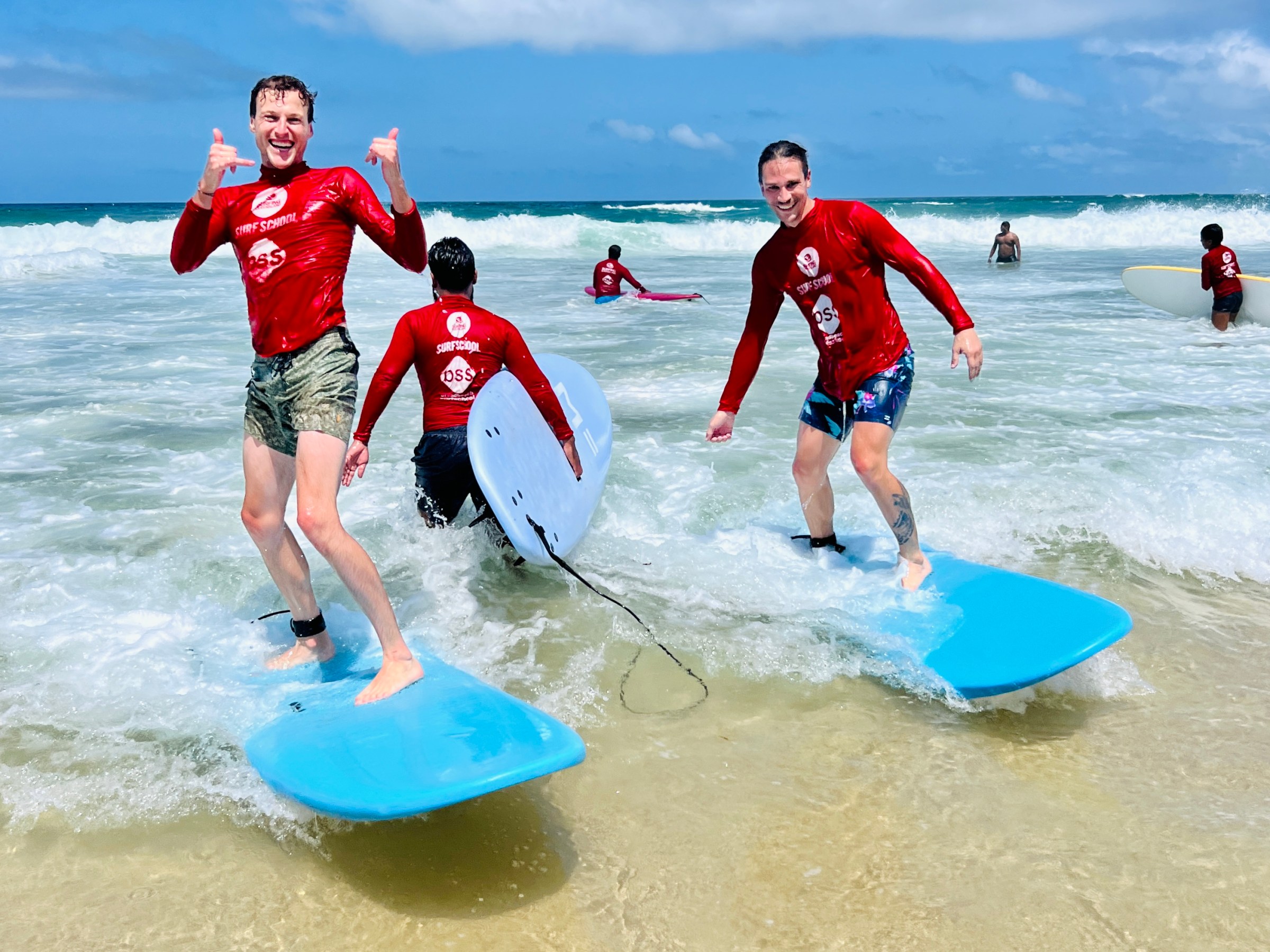a group of people riding skis on a beach