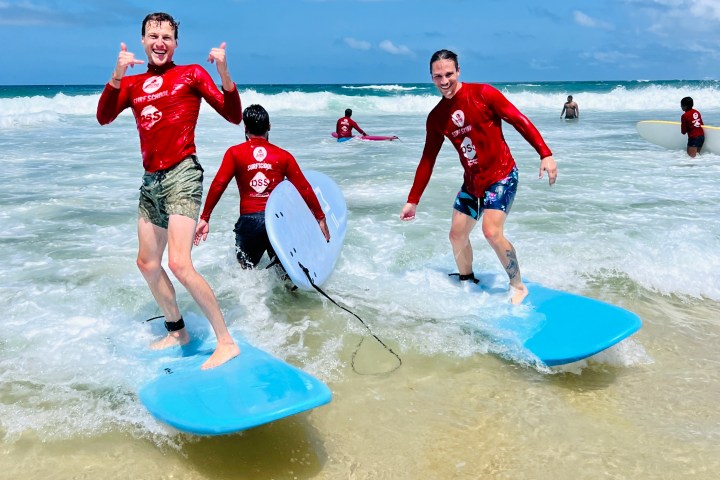 a group of people riding skis on a beach
