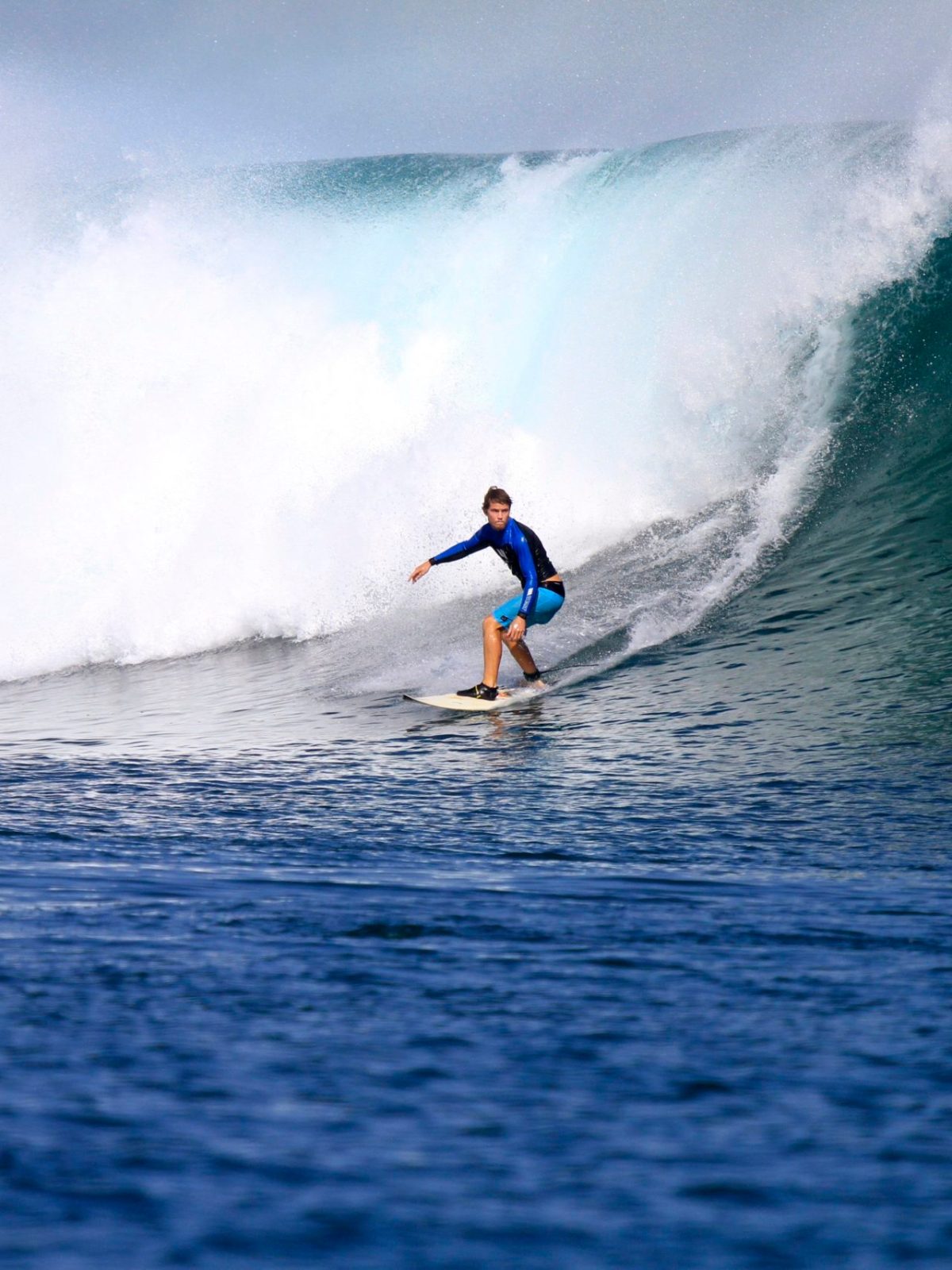 a man riding a wave on a surfboard in the ocean