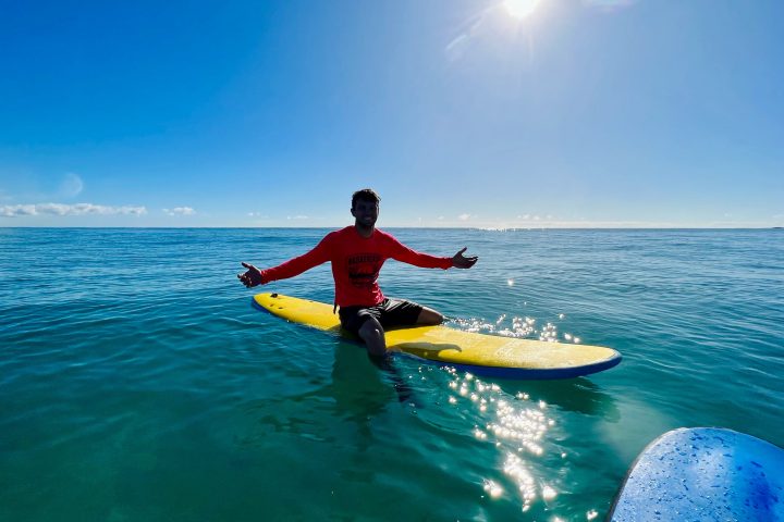 a person riding a surf board on a body of water