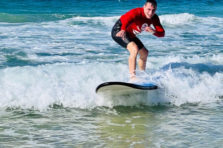 a man riding a wave on a surfboard in the ocean