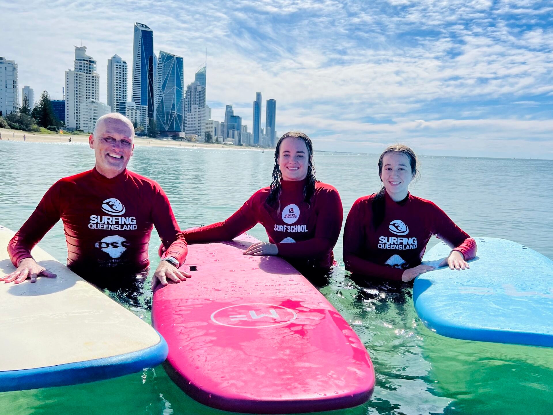 a group of people standing next to a body of water