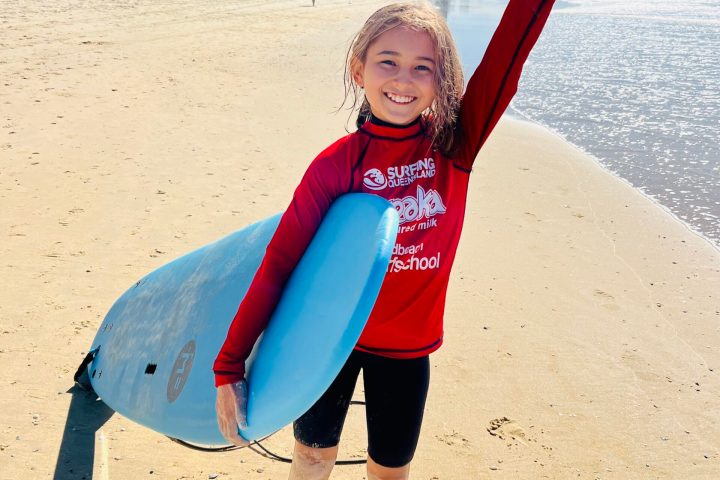 a person standing on a beach posing for the camera