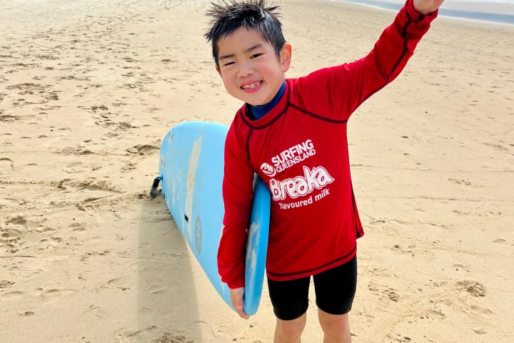 a young boy standing on a beach