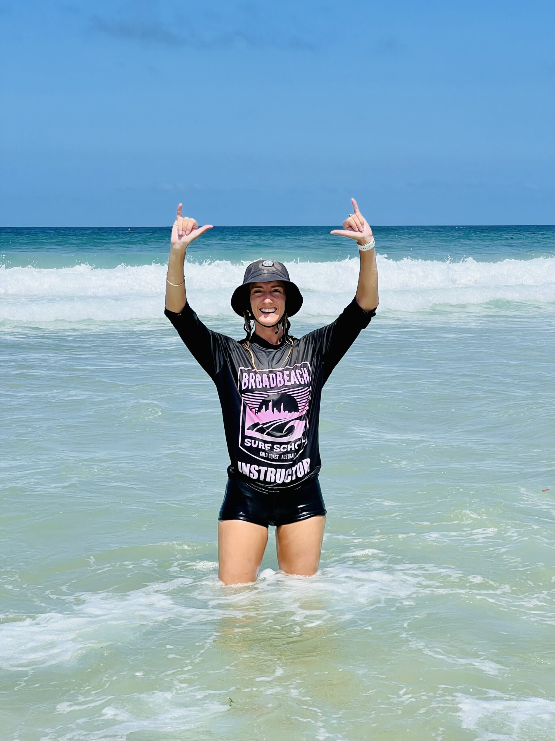 a woman standing next to a body of water