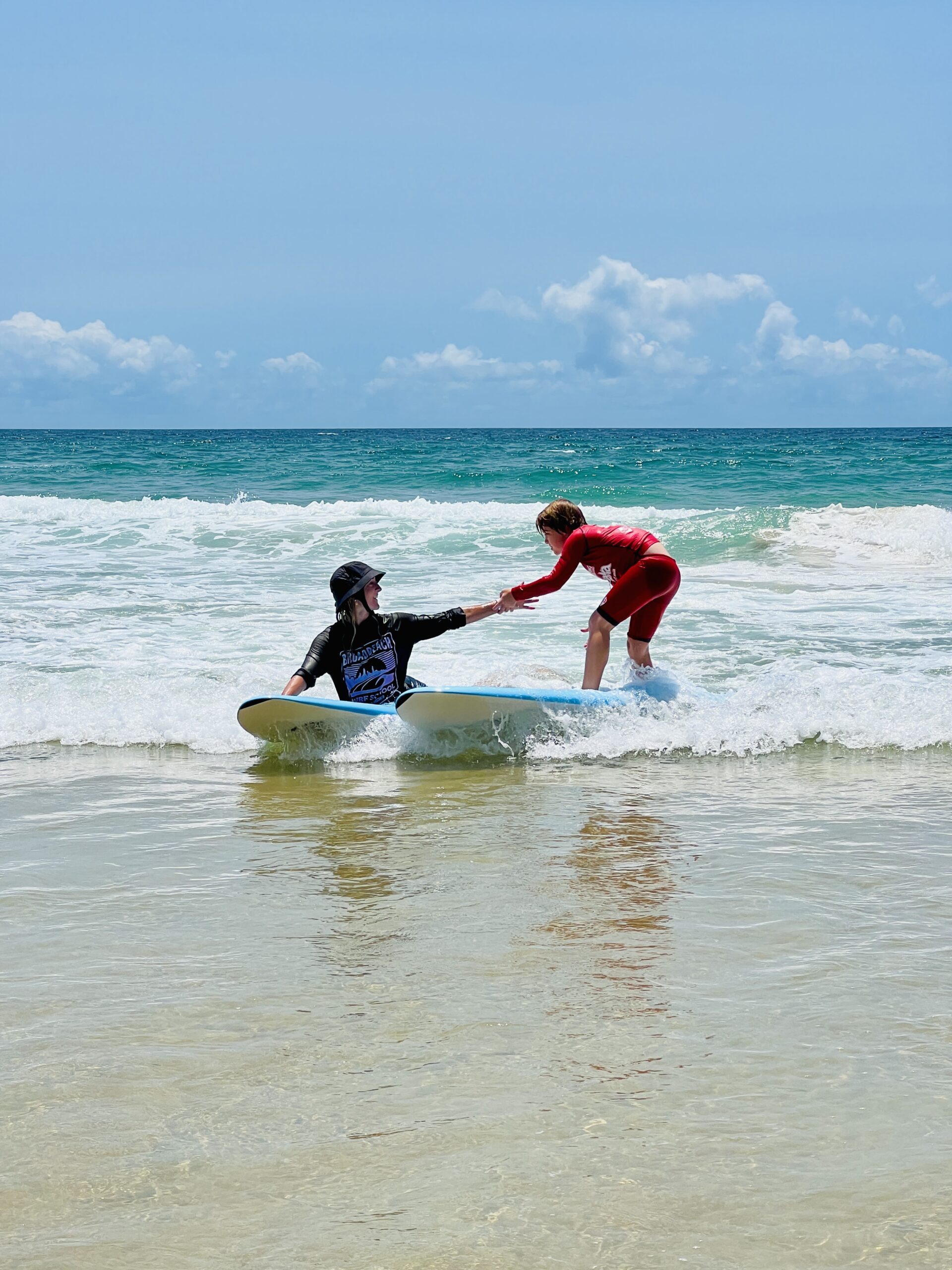 a man riding a wave on a surf board on a body of water