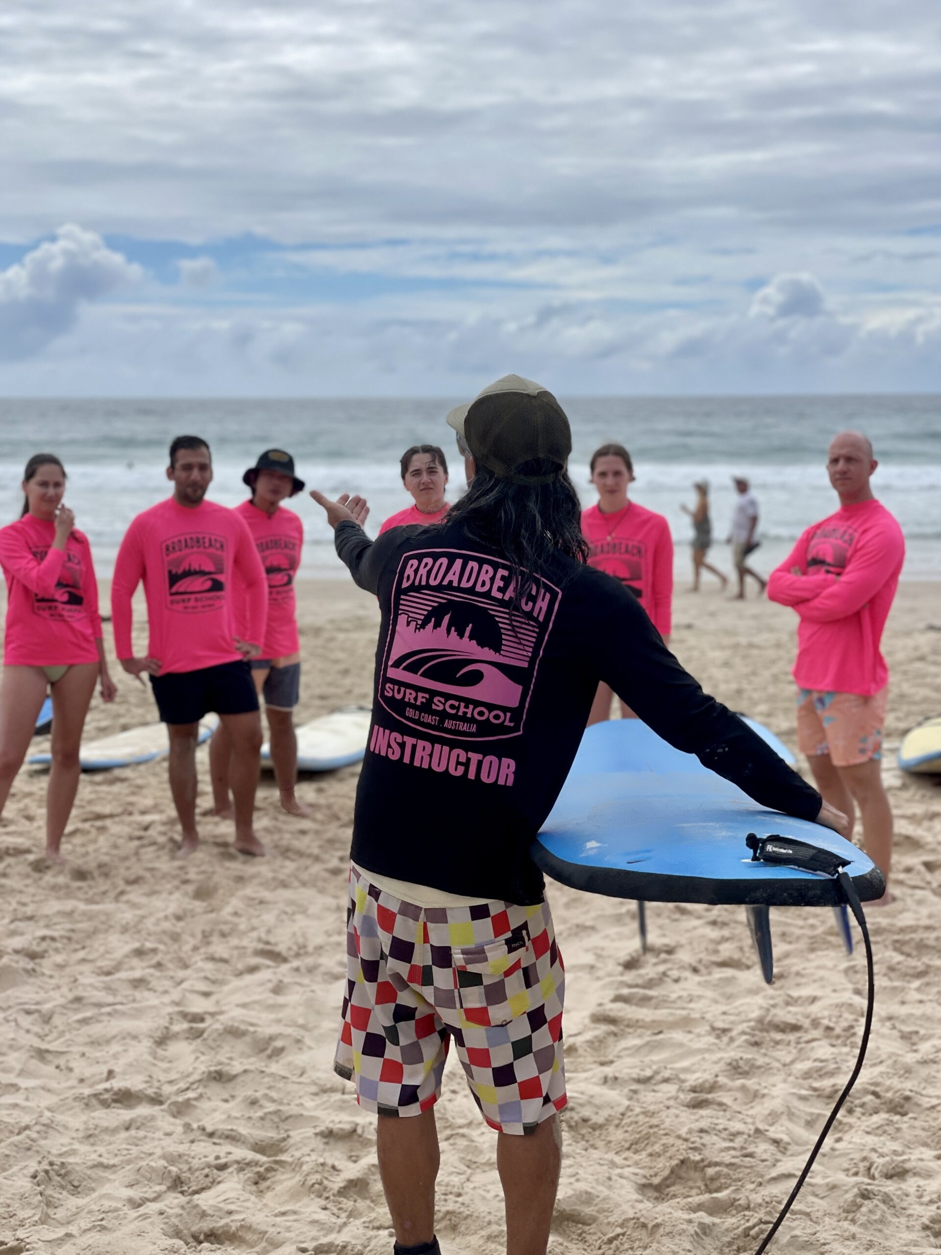 a group of people standing on top of a sandy beach